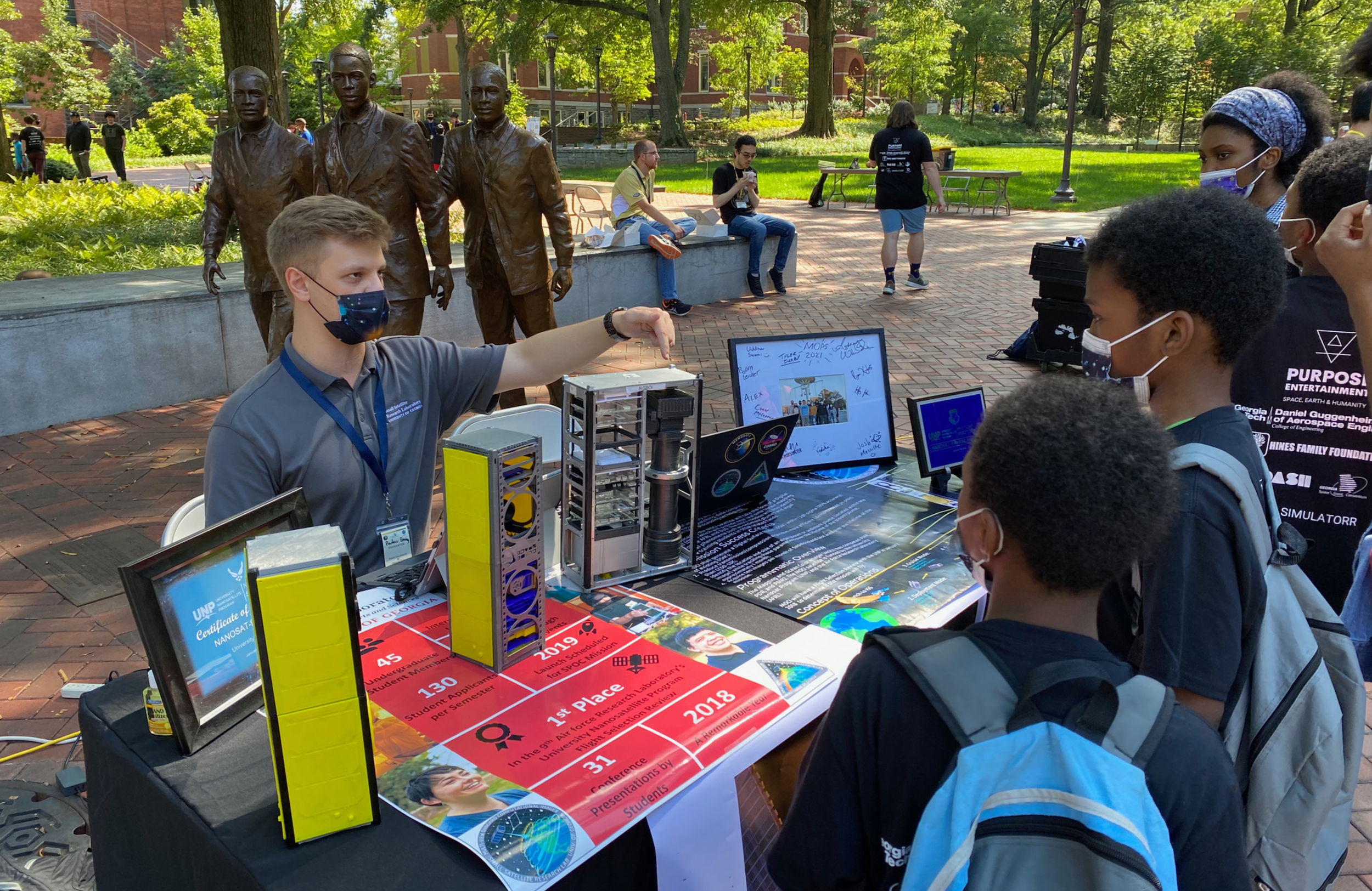 Younger students talking to college student